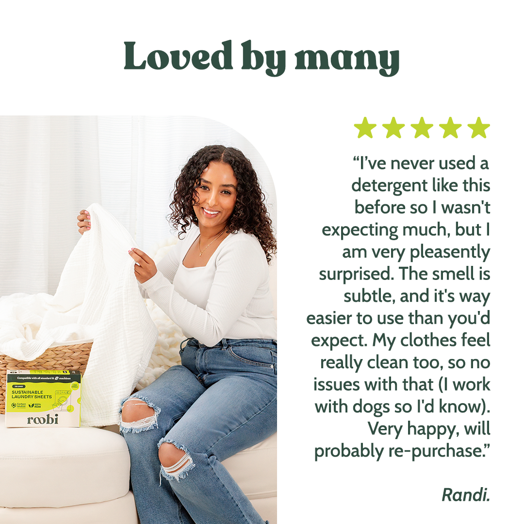 A Roobi customer folding fresh laundry with the sheets box beside her